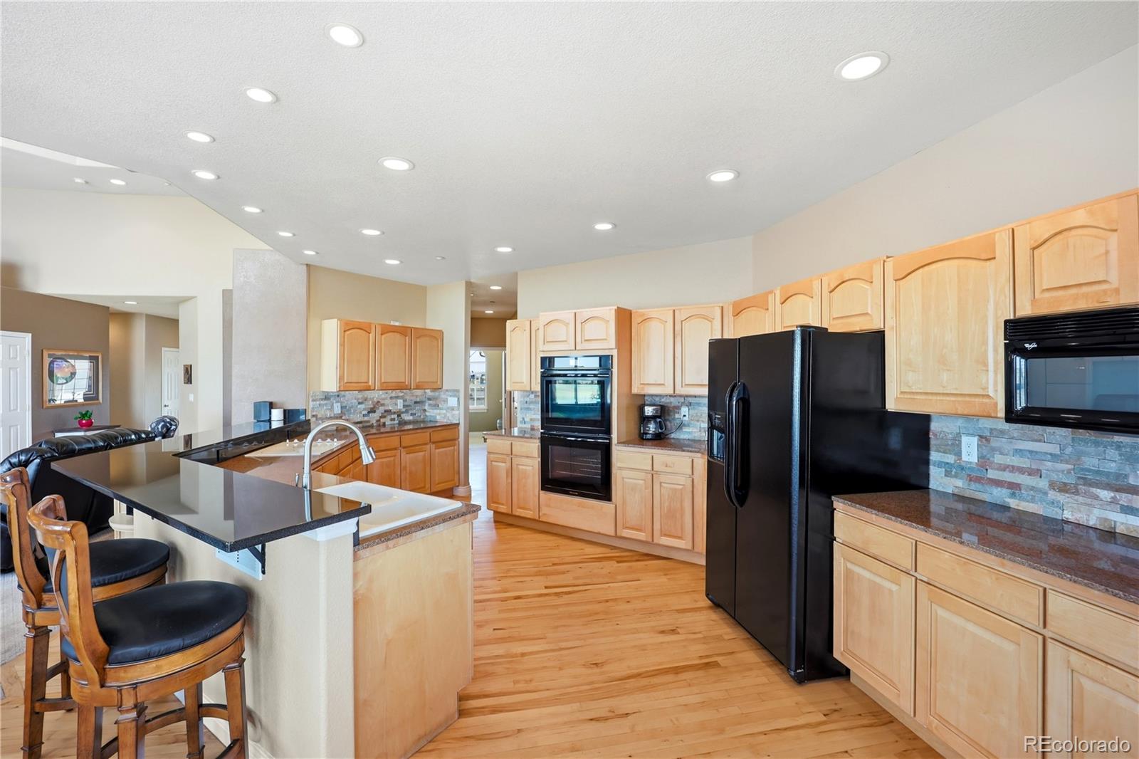 Kitchen & great room at 35880 E 149th Ct