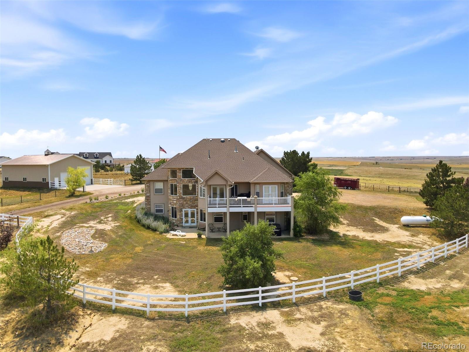 Rear exterior, covered deck and fenced grounds of 35880 E 149th Ct